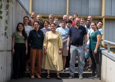 Group of people standing in front of a building, photo of RTG 2767 fellows and principal investigators at the 2022 summer school